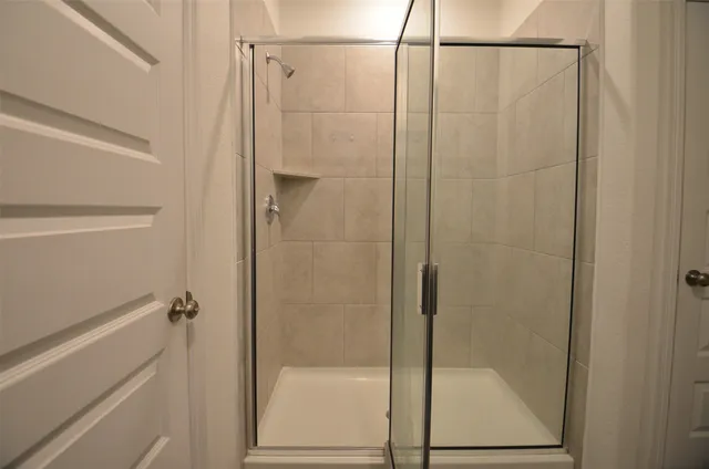 a bathroom with a glass shower door
