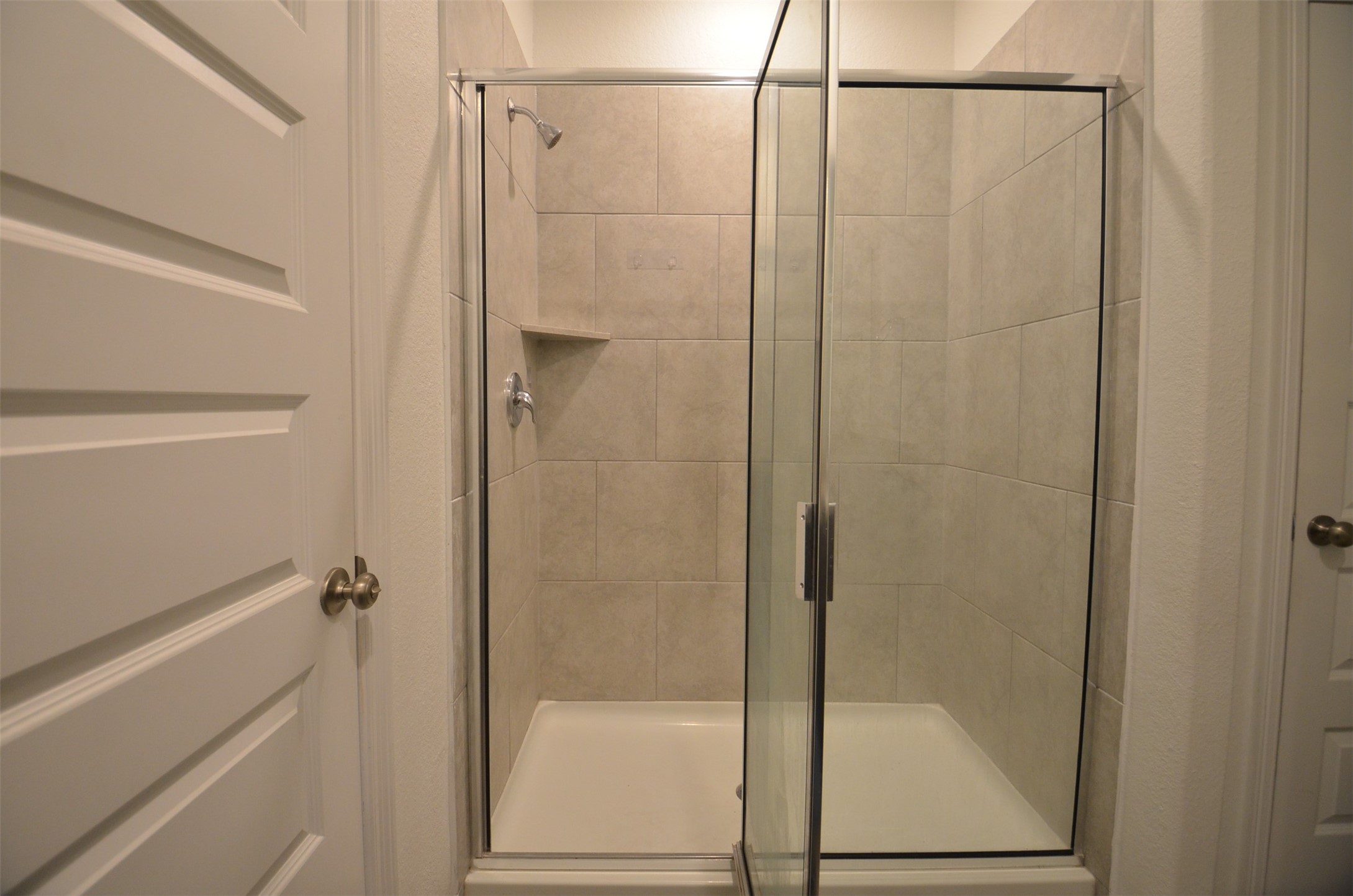 5602 Tabula Rasa Drive Katy, TX 77493 - Photo 14 of 38 a bathroom with a glass shower door