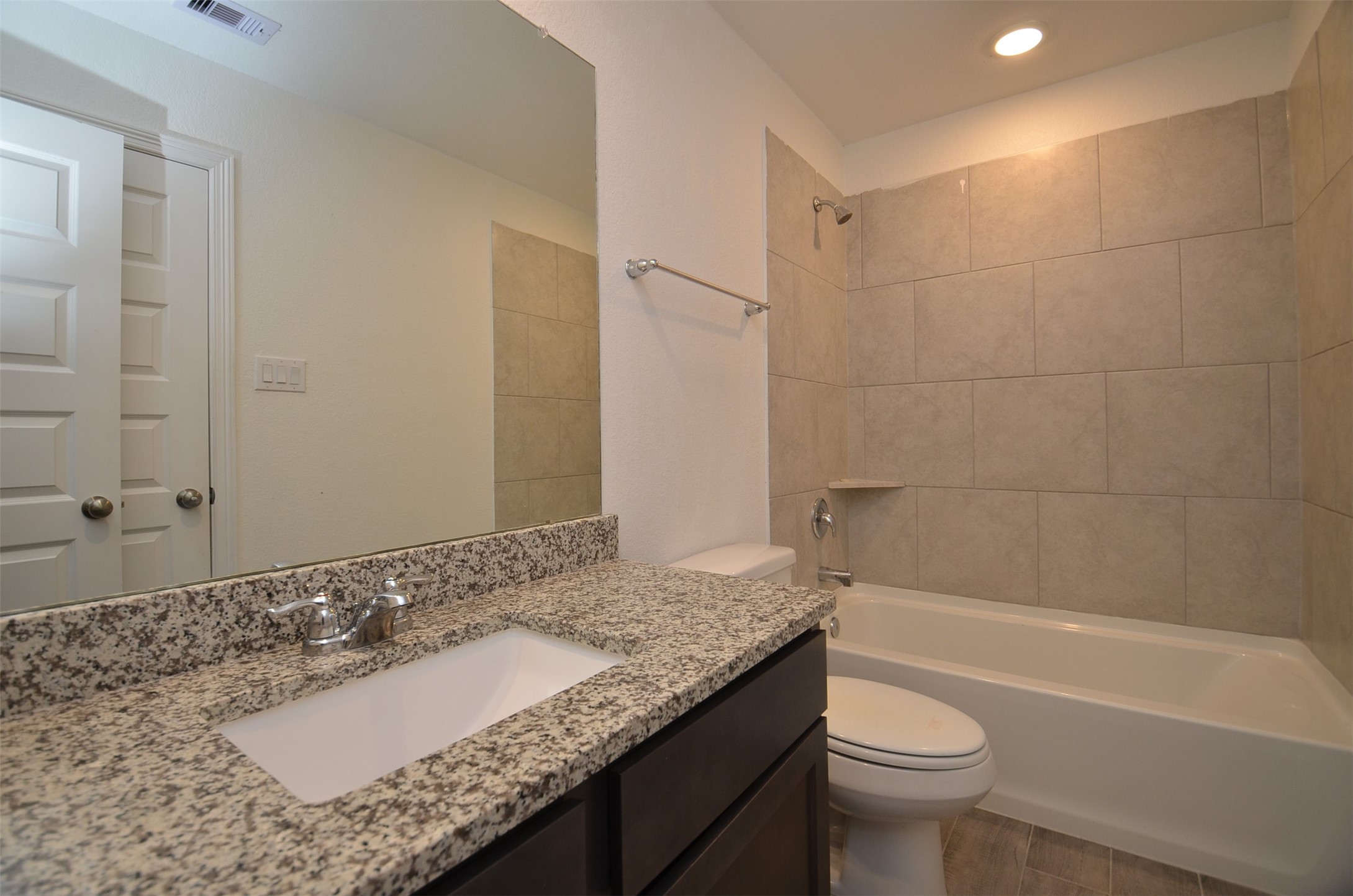 5602 Tabula Rasa Drive Katy, TX 77493 - Photo 22 of 38 a bathroom with a granite countertop sink a toilet and bathtub