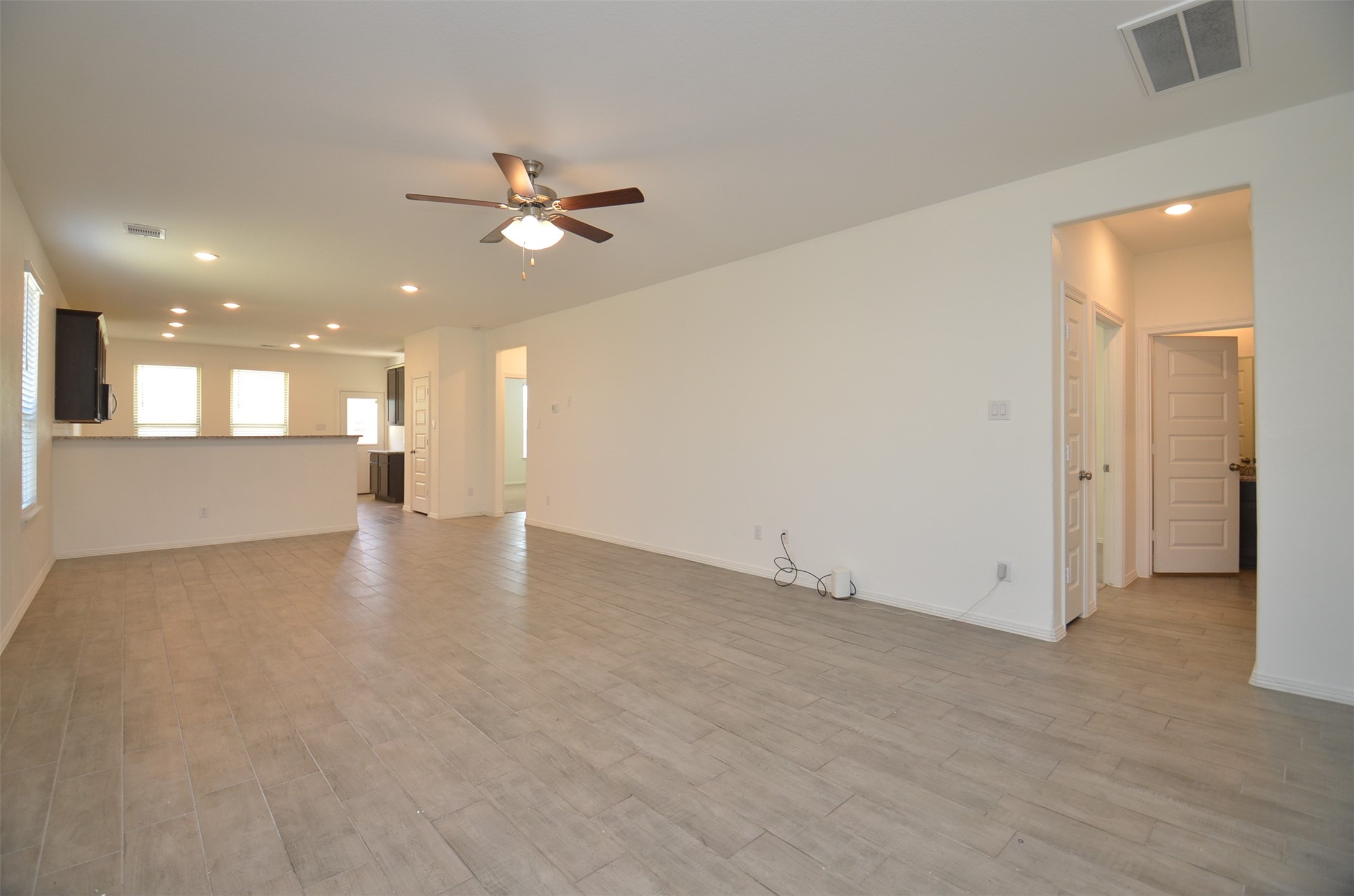 5602 Tabula Rasa Drive Katy, TX 77493 - Photo 5 of 38 an empty room with fan and kitchen view