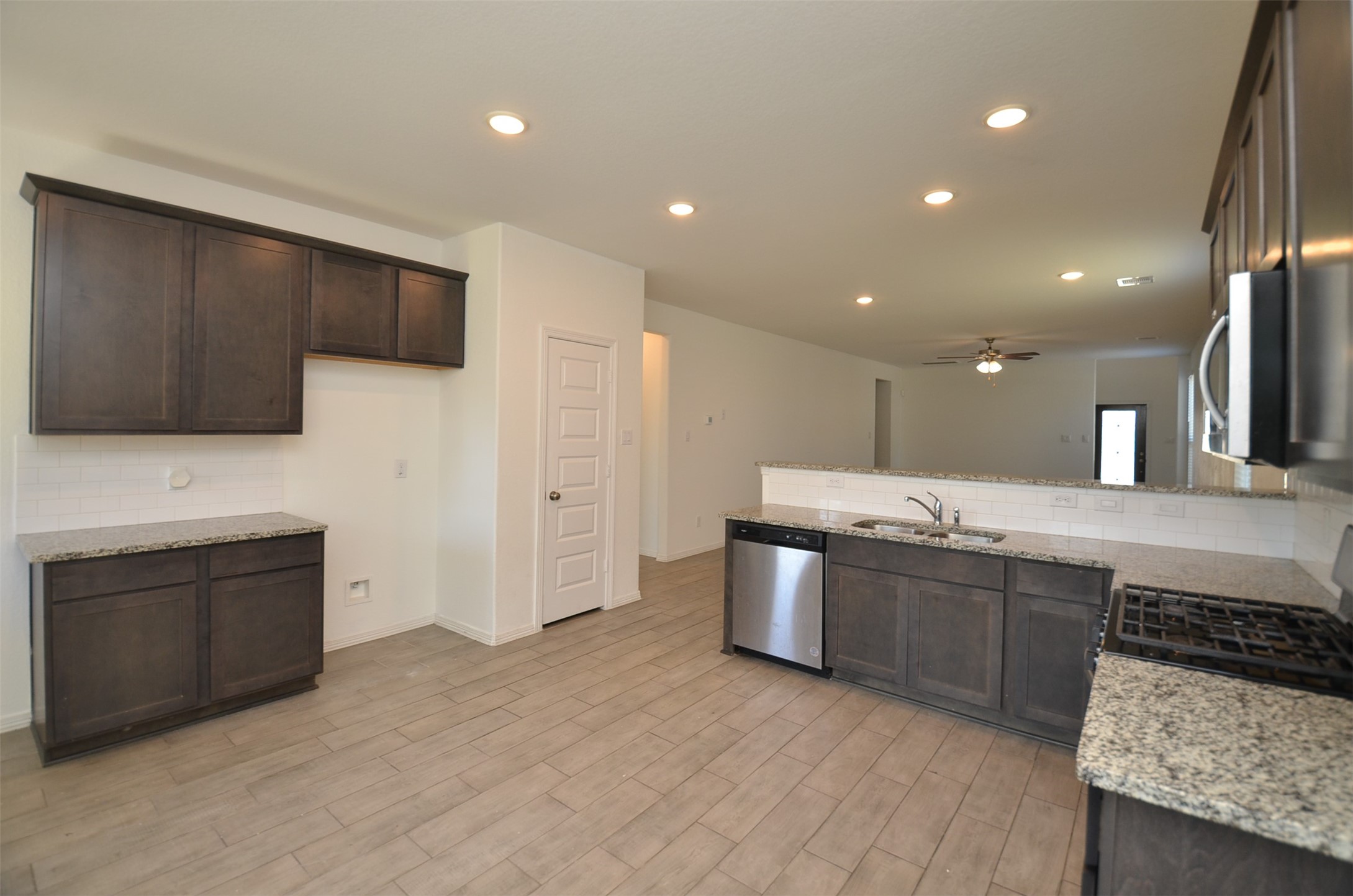 5602 Tabula Rasa Drive Katy, TX 77493 - Photo 9 of 38 a large kitchen with stainless steel appliances granite countertop a sink and a stove