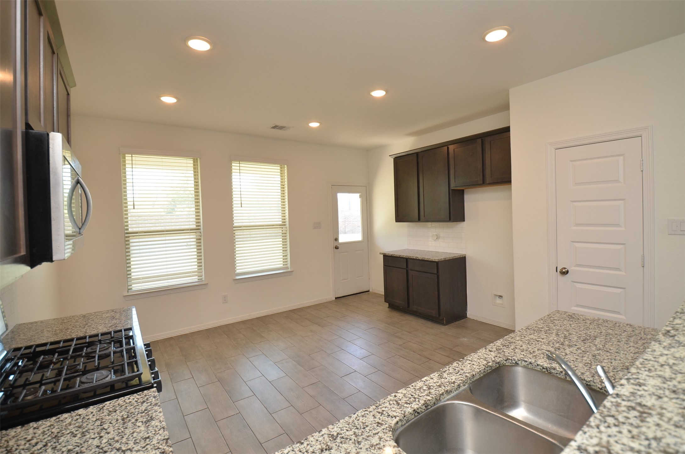 5602 Tabula Rasa Drive Katy, TX 77493 - Photo 10 of 38 a kitchen with a refrigerator and a stove top oven