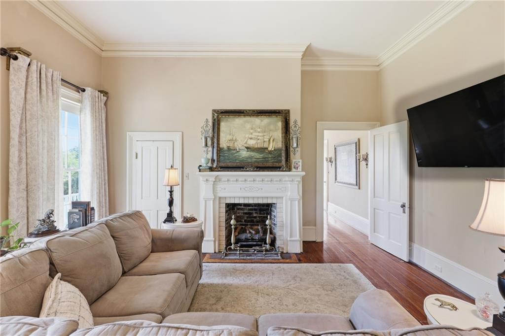 8075 Lakeview Road Statesboro, GA 30461 - Photo 11 of 46 a living room with furniture flat screen tv and a fireplace