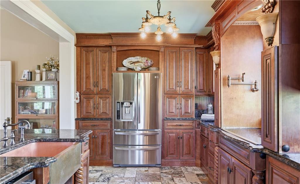 8075 Lakeview Road Statesboro, GA 30461 - Photo 19 of 46 a kitchen with refrigerator and cabinets