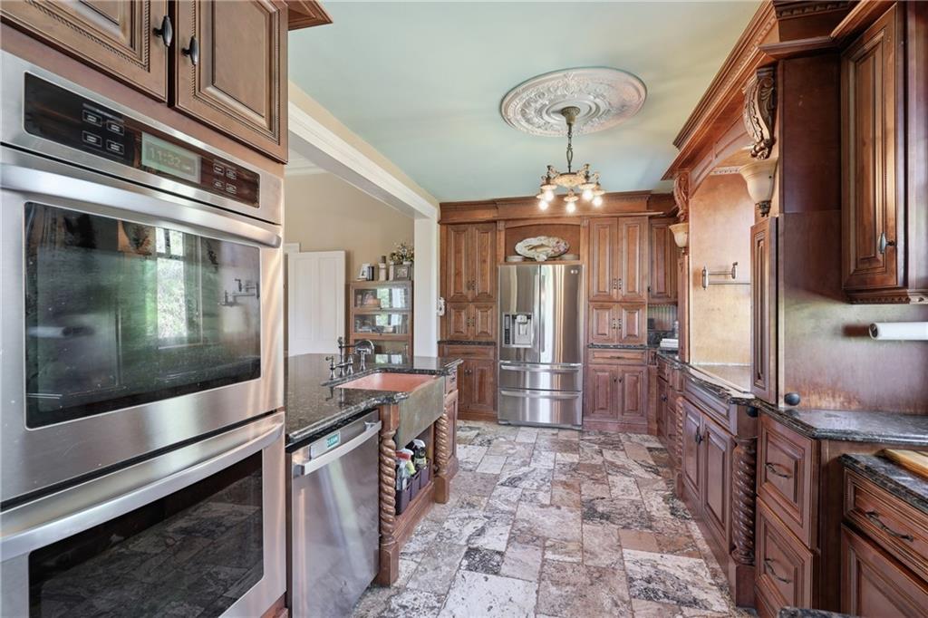 8075 Lakeview Road Statesboro, GA 30461 - Photo 20 of 46 a kitchen with stainless steel appliances a stove a refrigerator and a microwave