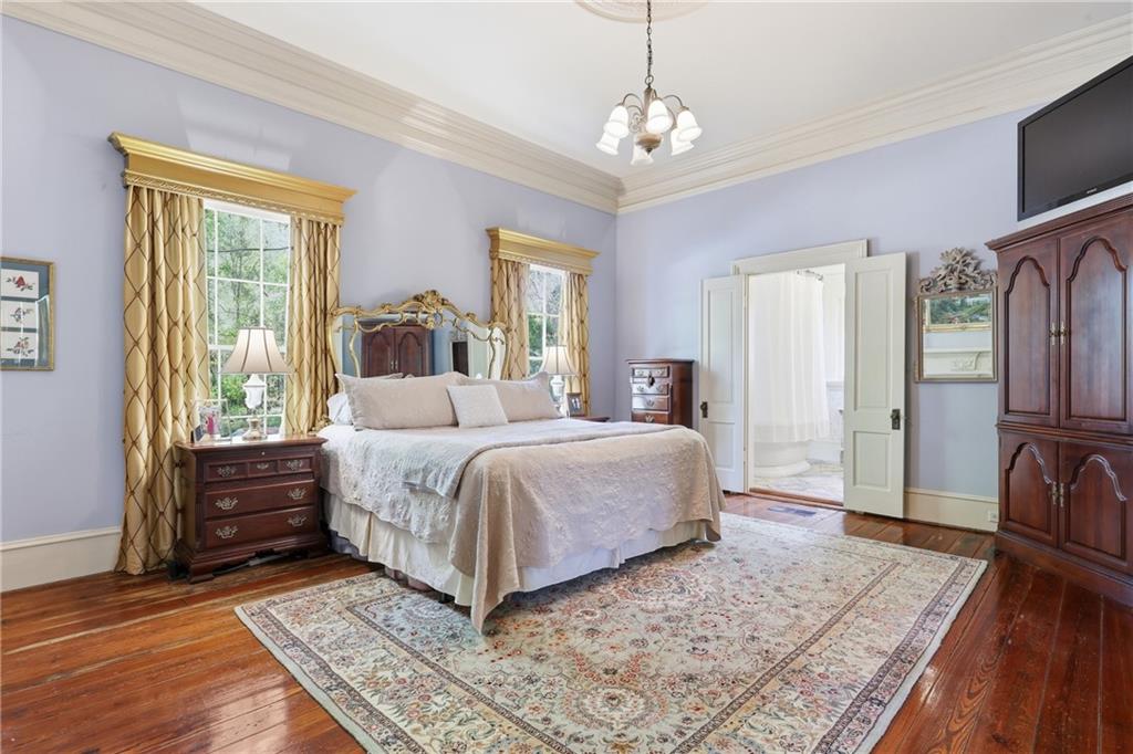 8075 Lakeview Road Statesboro, GA 30461 - Photo 22 of 46 a spacious bedroom with a bed and wooden floor