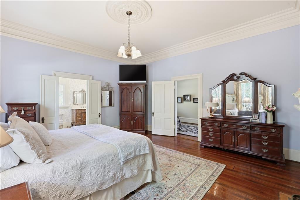 8075 Lakeview Road Statesboro, GA 30461 - Photo 23 of 46 a spacious bedroom with a bed and a dresser in it