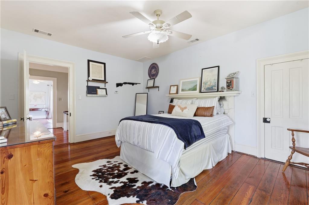 8075 Lakeview Road Statesboro, GA 30461 - Photo 28 of 46 a bedroom with a bed and a chandelier