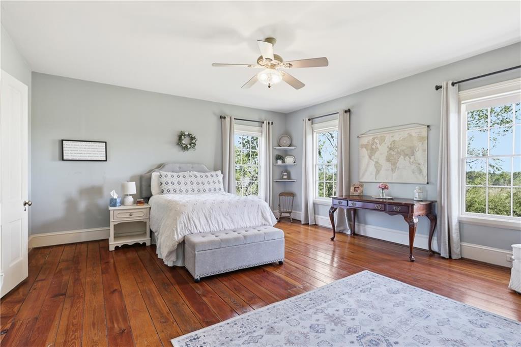 8075 Lakeview Road Statesboro, GA 30461 - Photo 30 of 46 a spacious bedroom with a bed and a table in it