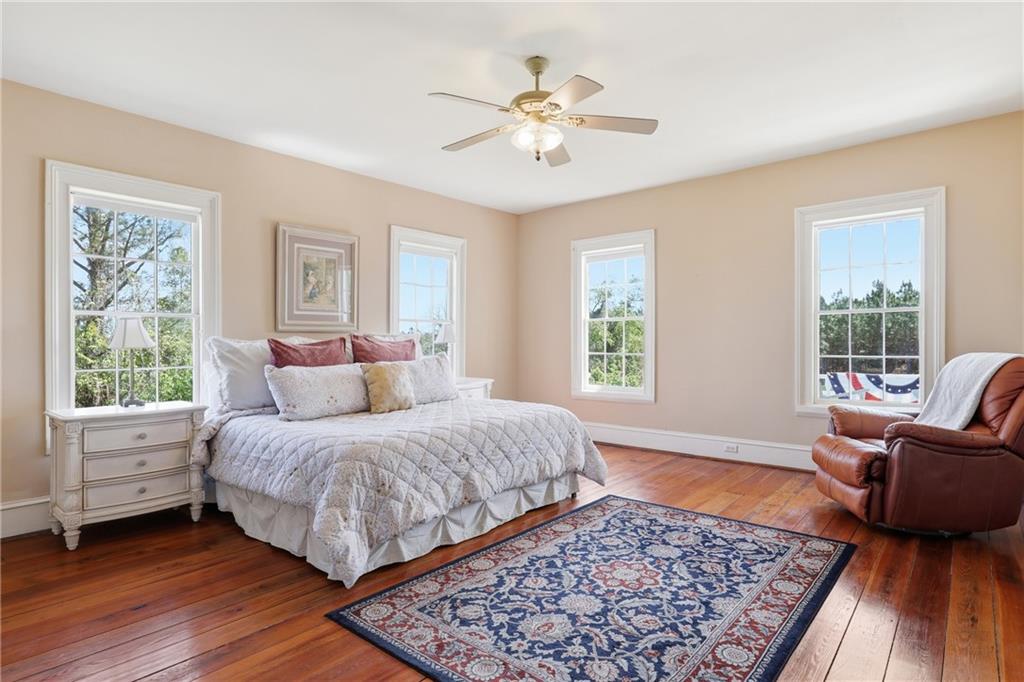 8075 Lakeview Road Statesboro, GA 30461 - Photo 34 of 46 a bedroom with a large bed and a couch