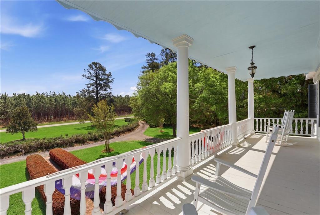 8075 Lakeview Road Statesboro, GA 30461 - Photo 38 of 46 a view of a deck with a big yard potted plants and large tree