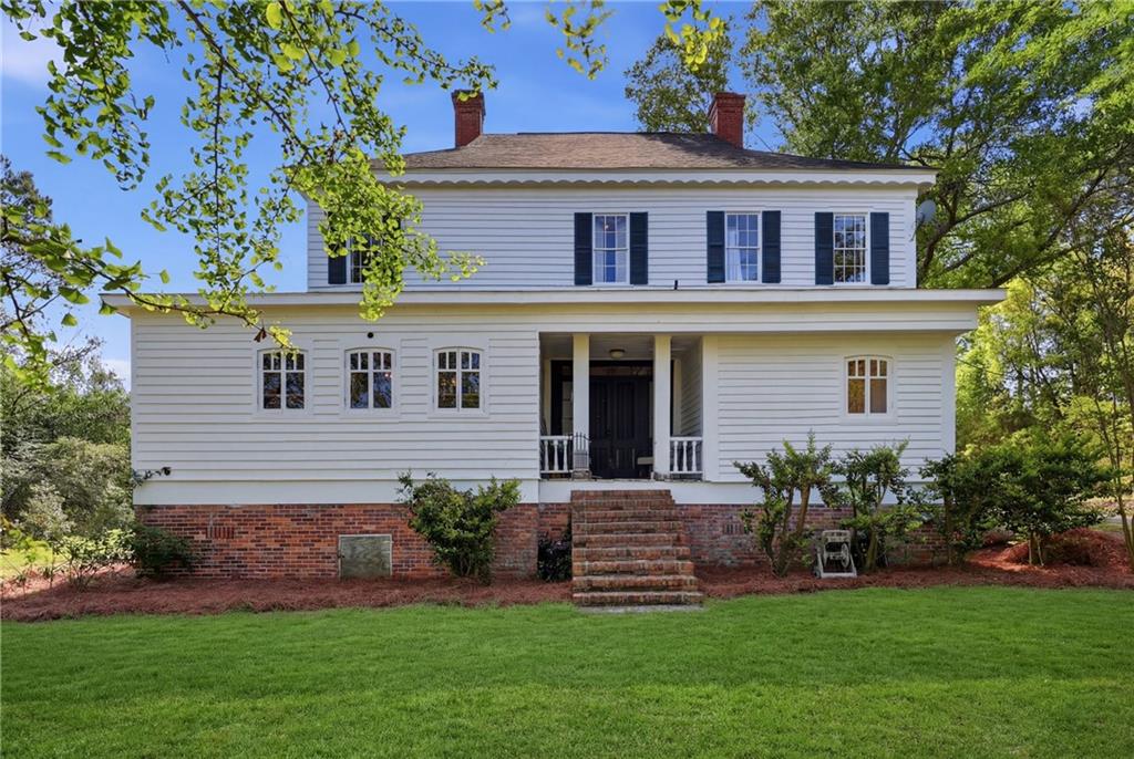 8075 Lakeview Road Statesboro, GA 30461 - Photo 41 of 46 a front view of a house with a garden