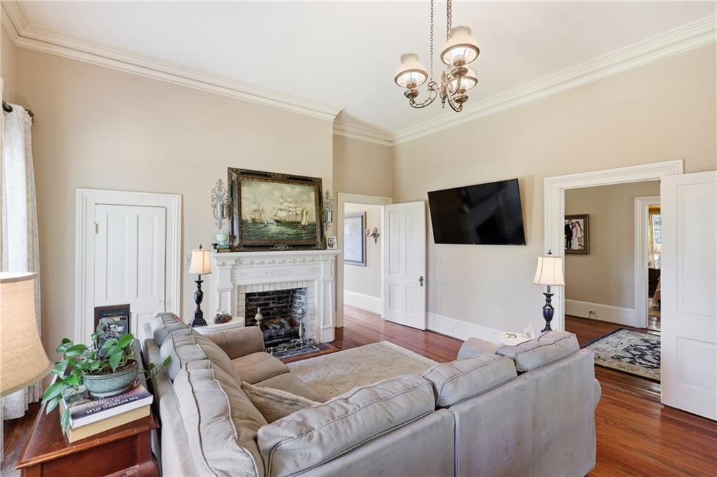 8075 Lakeview Road Statesboro, GA 30461 - Photo 10 of 46 a living room with furniture a fireplace and a flat screen tv