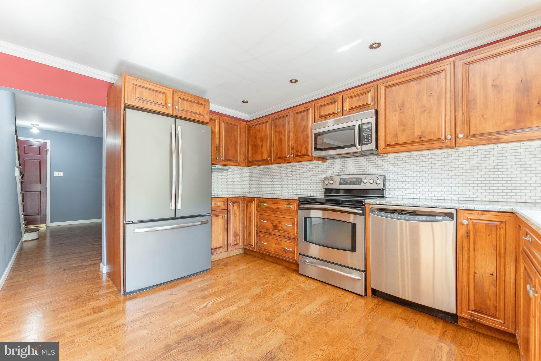 281 West Avenue Springfield, PA 19064 - Photo 16 of 51 a kitchen with granite countertop a refrigerator and a stove top oven