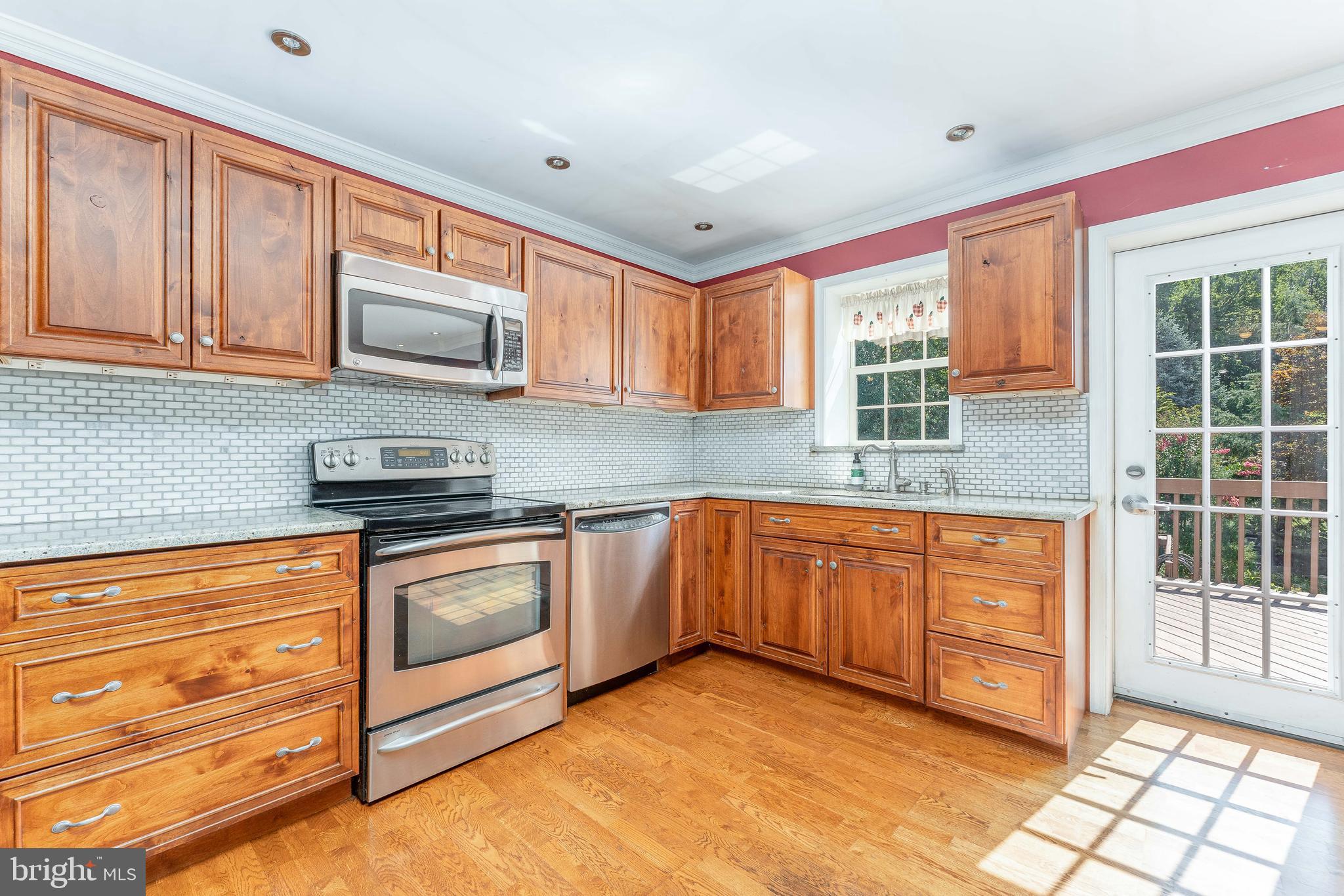 281 West Avenue Springfield, PA 19064 - Photo 17 of 51 a kitchen with stainless steel appliances granite countertop a stove a sink and a microwave