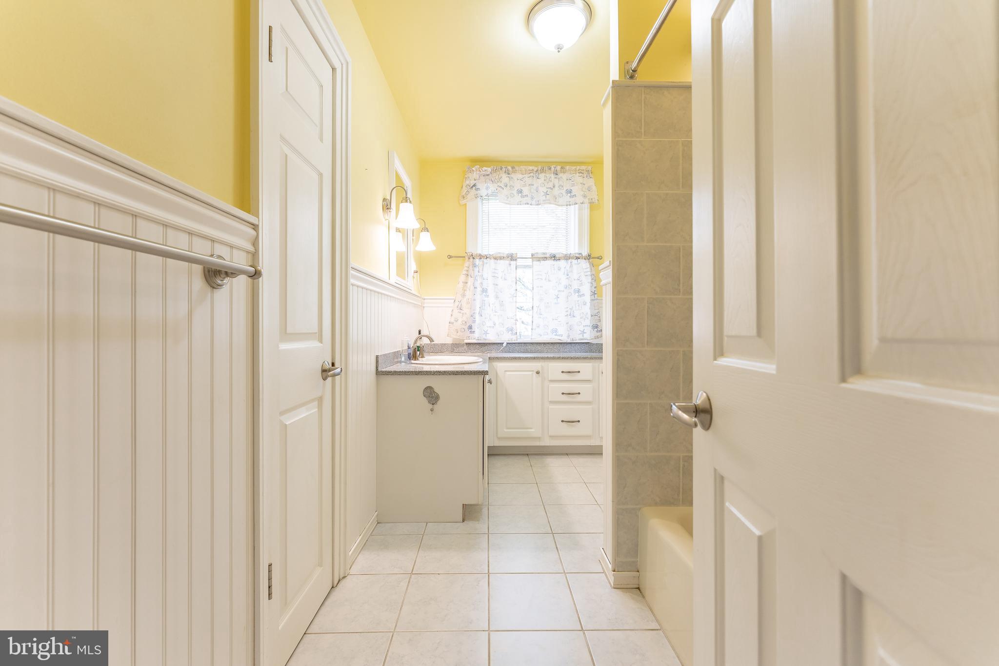 281 West Avenue Springfield, PA 19064 - Photo 23 of 51 a bathroom with a granite countertop sink and a mirror