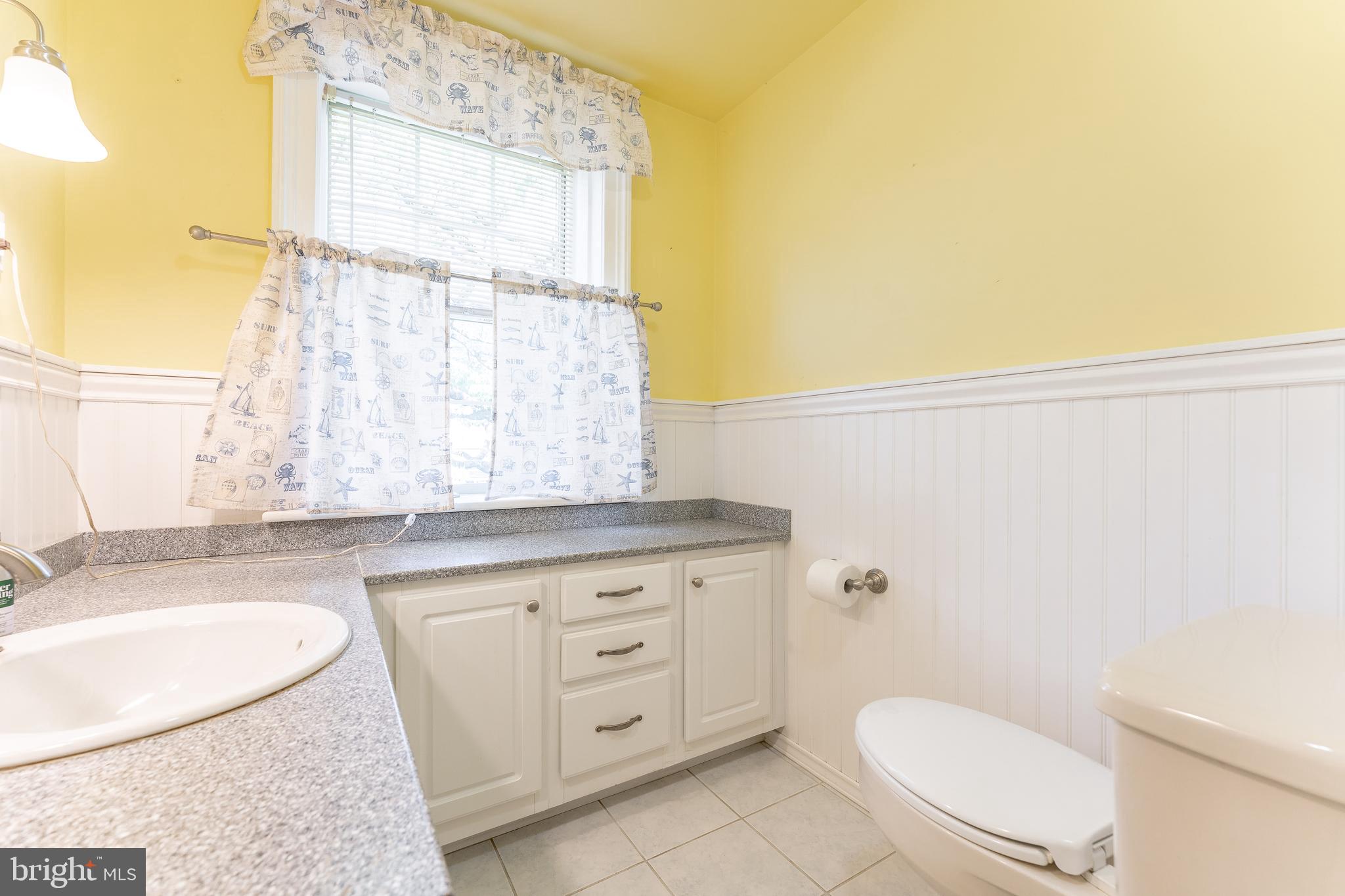 281 West Avenue Springfield, PA 19064 - Photo 24 of 51 a bathroom with a granite countertop sink a toilet and tub