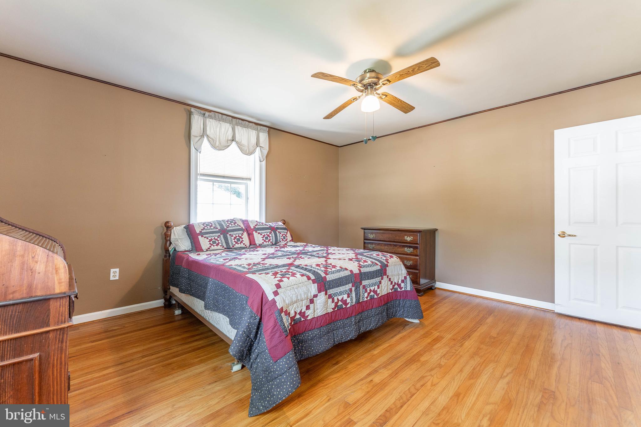 281 West Avenue Springfield, PA 19064 - Photo 32 of 51 a bedroom with a bed and wooden floor