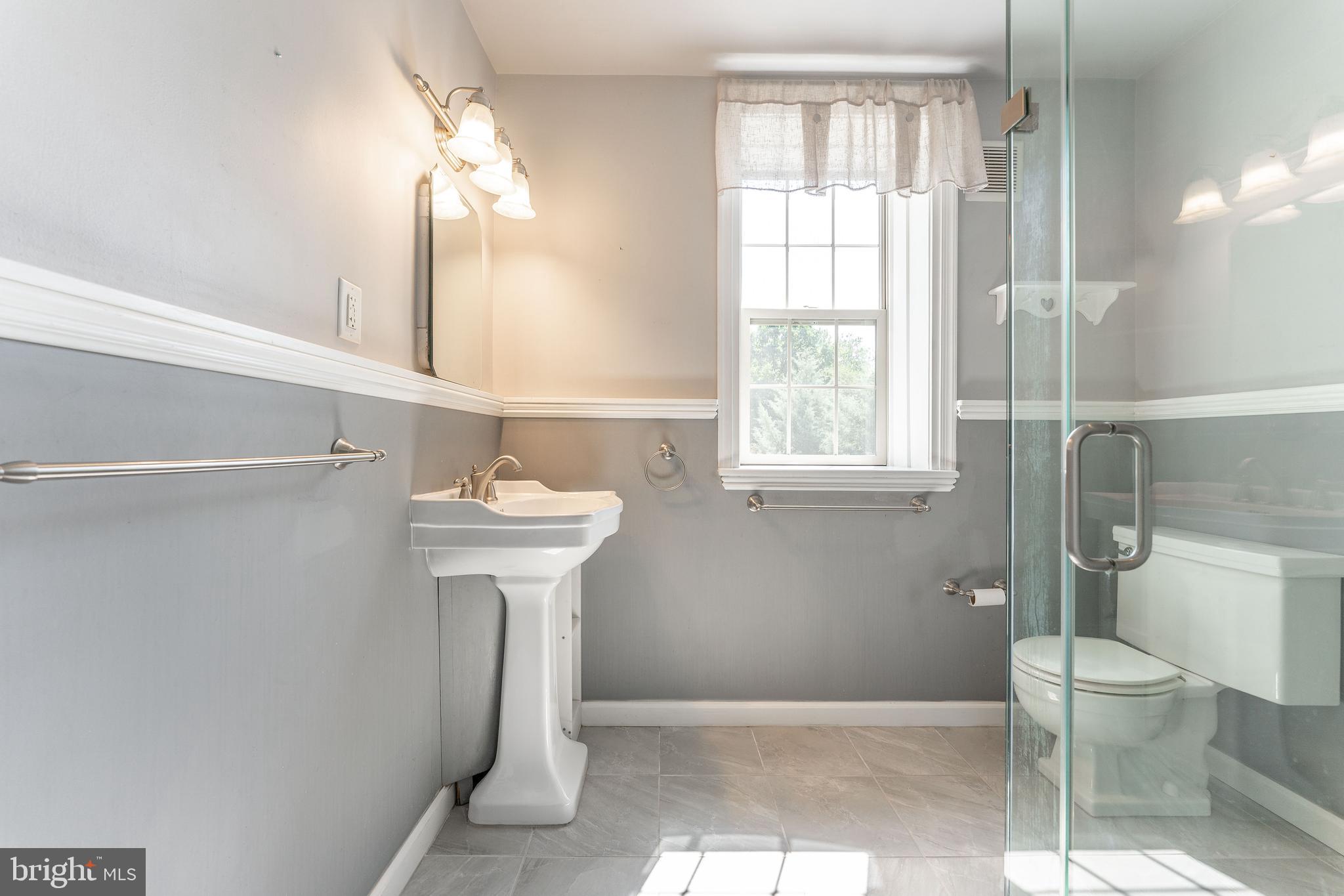 281 West Avenue Springfield, PA 19064 - Photo 41 of 51 a bathroom with a toilet sink and mirror