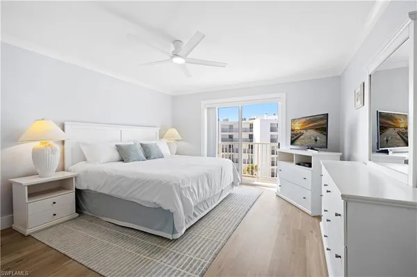 a bedroom with a large bed and a flat screen tv