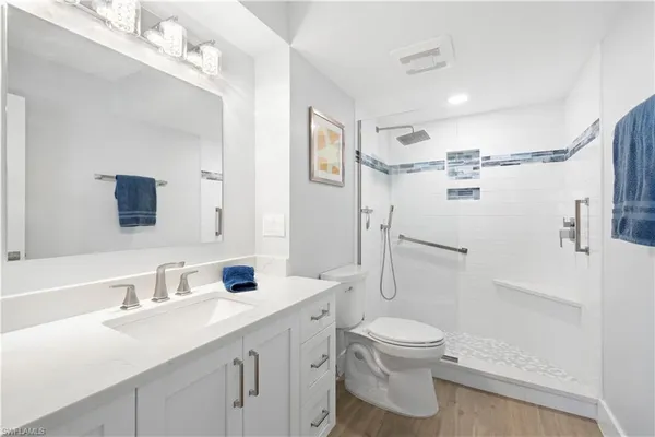 a bathroom with a sink toilet tub and shower