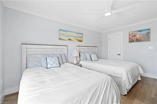 a bedroom with a bed and painting on the wall