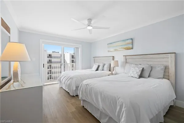 a bedroom with a bed a lamp and a large window