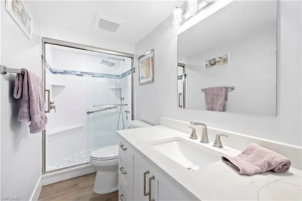 a bathroom with a sink toilet and shower