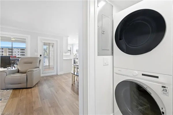 a living room with furniture and a washer dryer