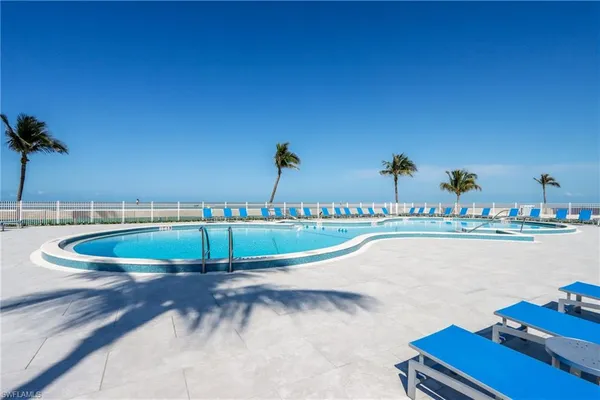 a view of a swimming pool with outdoor seating