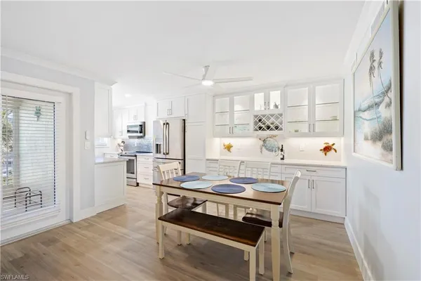 a kitchen with refrigerator cabinets and wooden floor