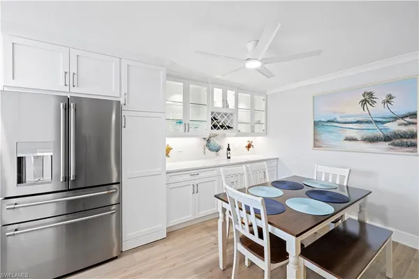 a kitchen with a refrigerator a sink and cabinets
