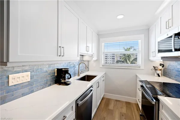 a kitchen with a sink cabinets and window
