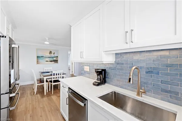 a kitchen with a sink cabinets and appliances