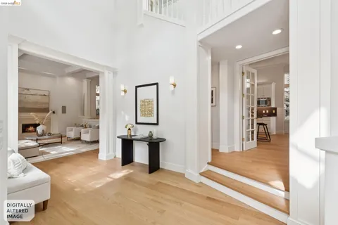 a living room with furniture large window and wooden floor