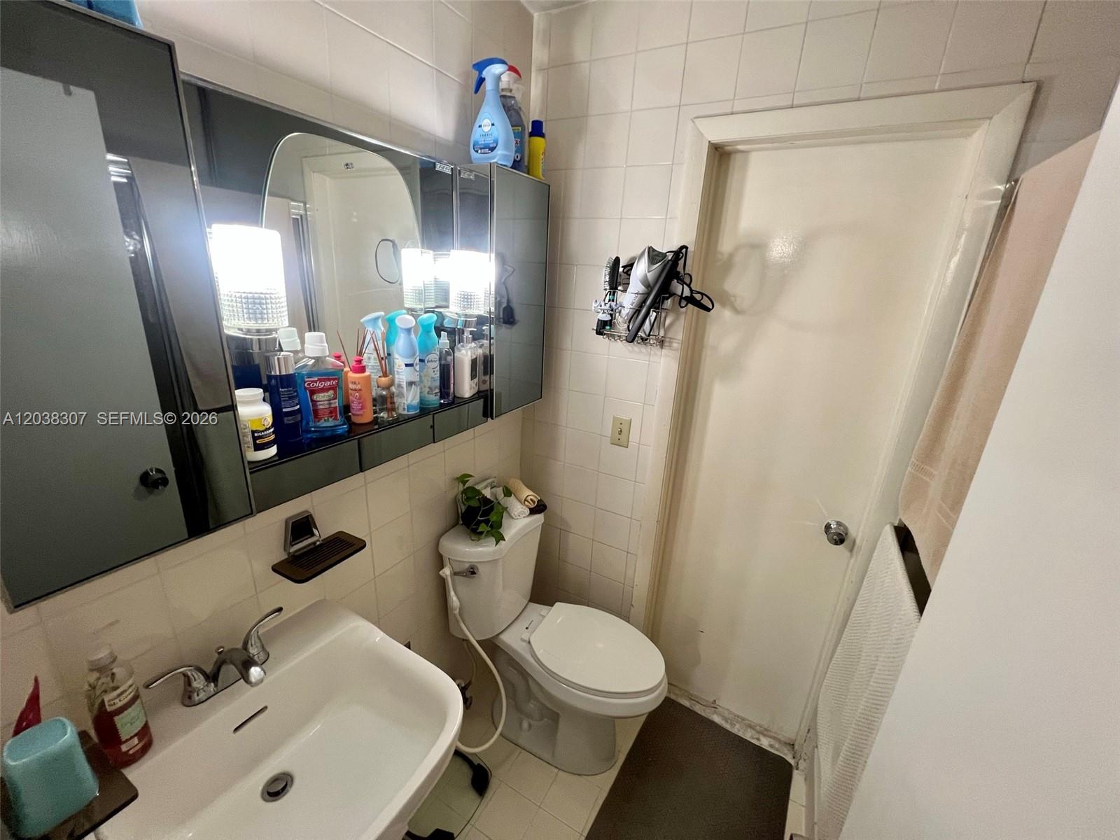 9601 Southwest 66th Street Miami, FL 33173 - Photo 48 of 62 a bathroom with a sink mirror vanity and toilet