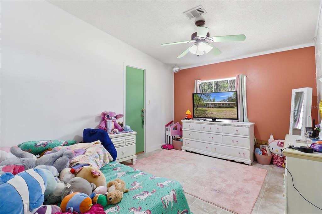 4950 West Mockingbird Street Homosassa, FL 34446 - Photo 17 of 47 a bedroom with a bed and a flat screen tv