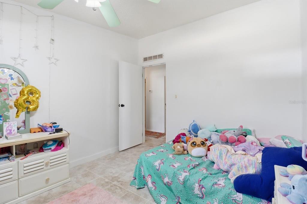 4950 West Mockingbird Street Homosassa, FL 34446 - Photo 18 of 47 a bedroom with bed and wooden floor