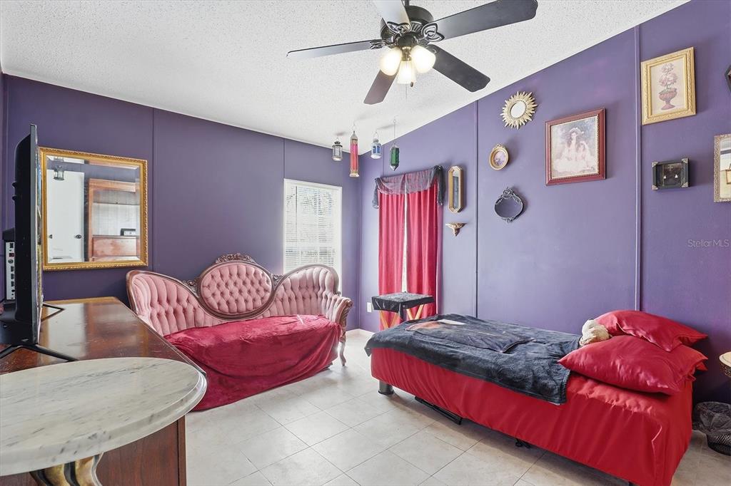 4950 West Mockingbird Street Homosassa, FL 34446 - Photo 19 of 47 a bedroom with a bed and ceiling fan