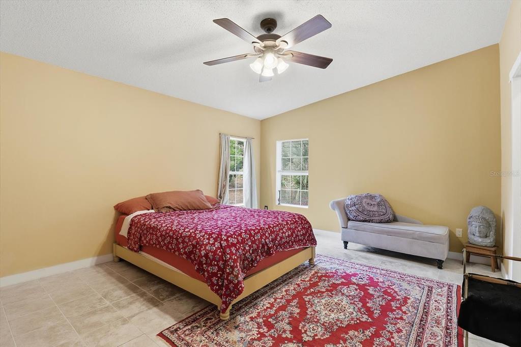 4950 West Mockingbird Street Homosassa, FL 34446 - Photo 23 of 47 a bedroom with a bed and a couch