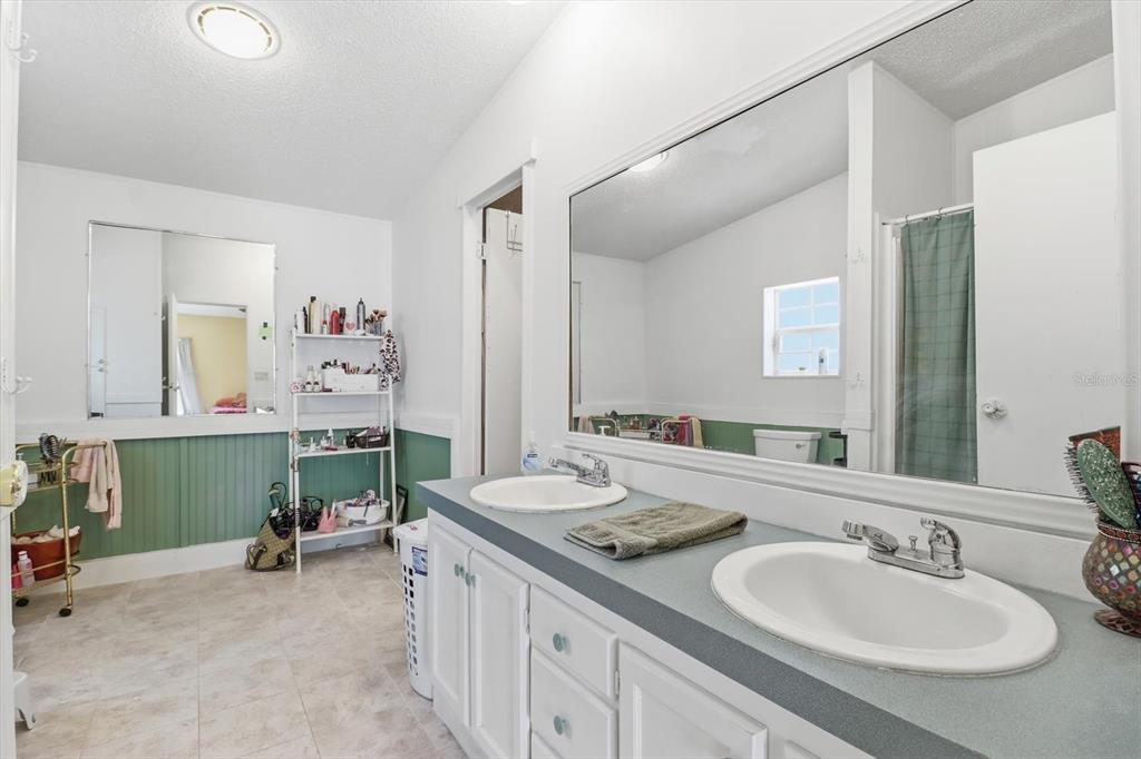 4950 West Mockingbird Street Homosassa, FL 34446 - Photo 26 of 47 a en suite bathroom with 2 sink and a mirror