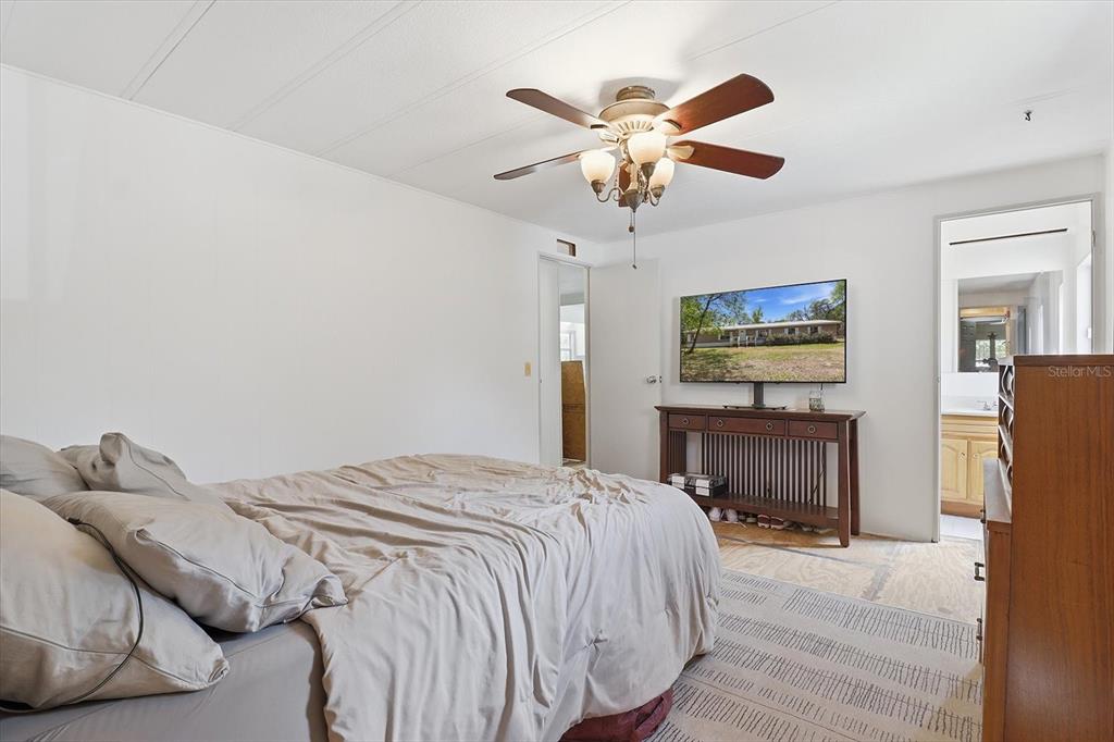 4950 West Mockingbird Street Homosassa, FL 34446 - Photo 28 of 47 a bedroom with a bed and a chandelier