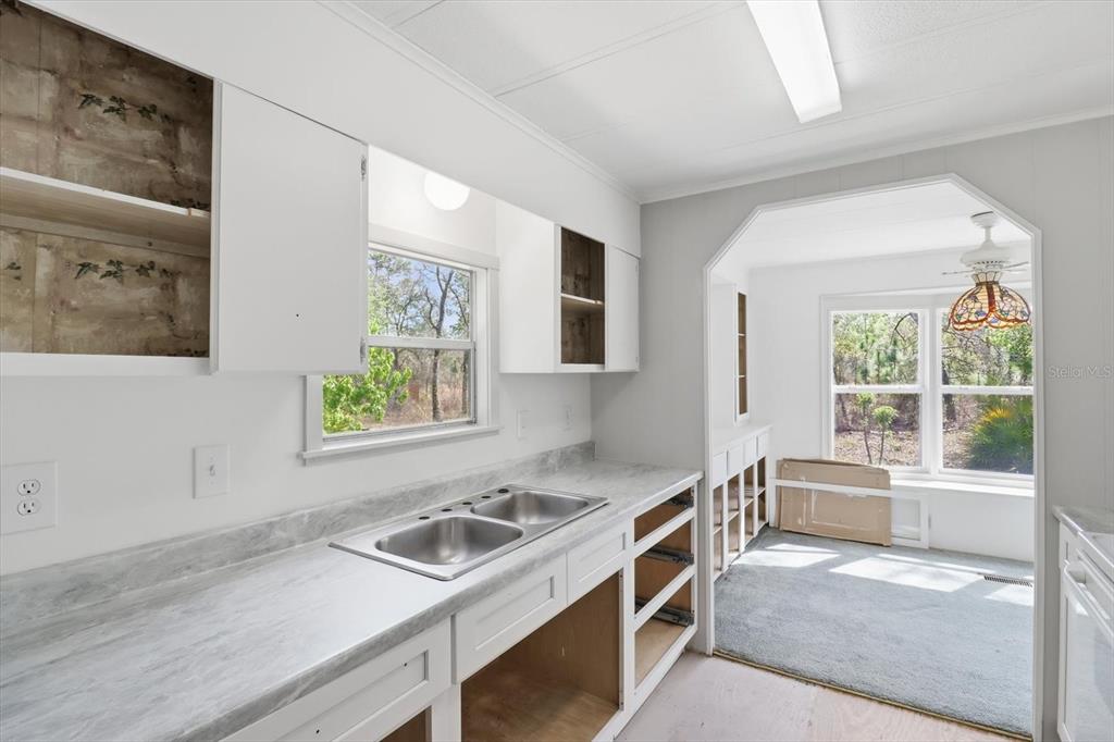 4950 West Mockingbird Street Homosassa, FL 34446 - Photo 38 of 47 a kitchen that has a stove and a sink