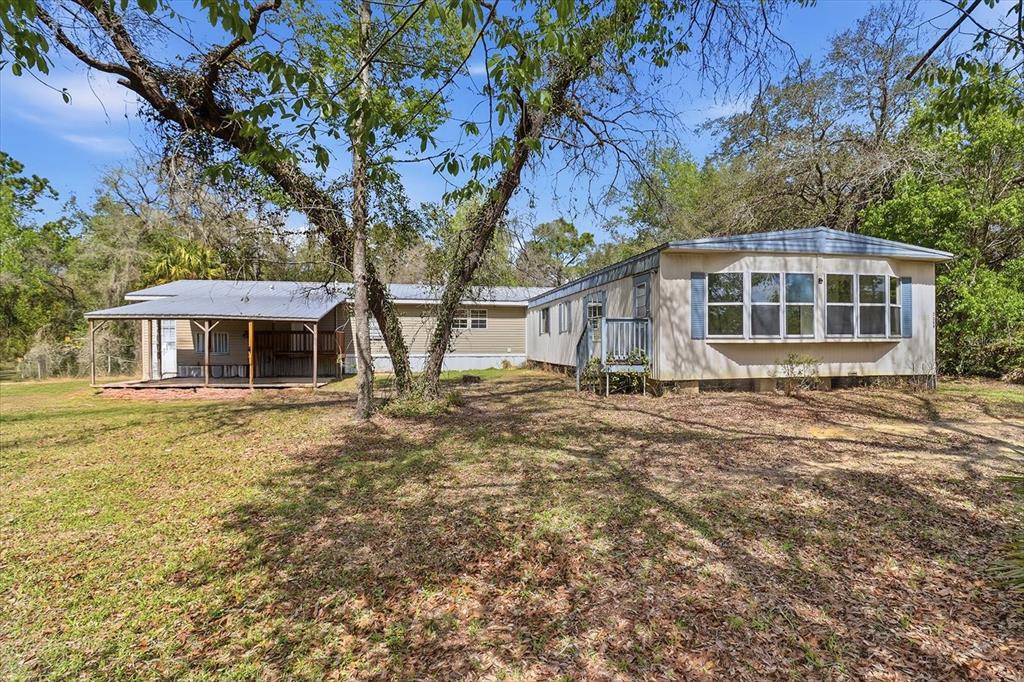 4950 West Mockingbird Street Homosassa, FL 34446 - Photo 39 of 47 a front view of a house with a garden