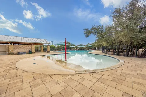 a swimming pool with an outdoor space and seating area