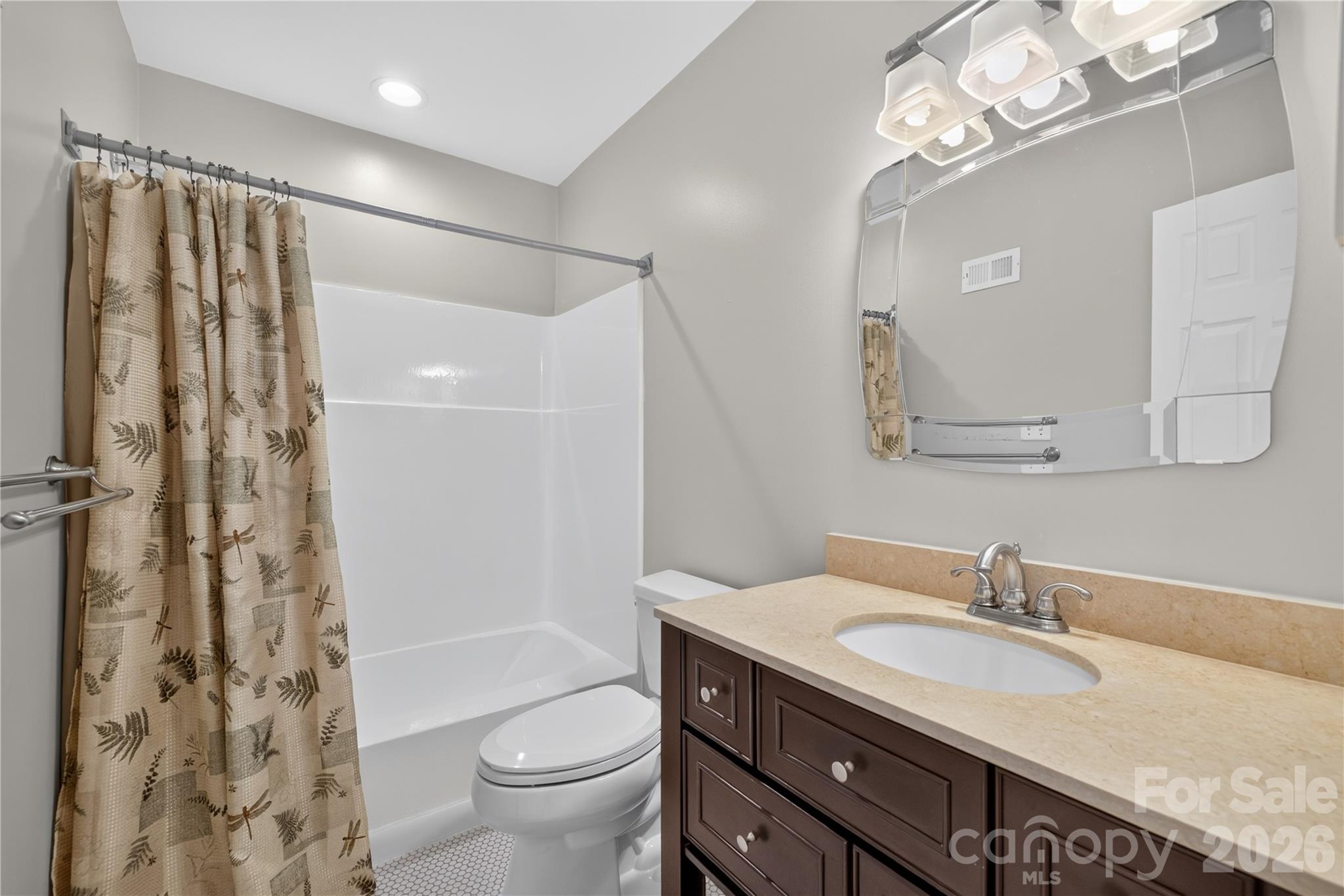 185 Riverview Terrace Clover, SC 29710 - Photo 20 of 35 a bathroom with a granite countertop sink a toilet a mirror a shower and a mirror