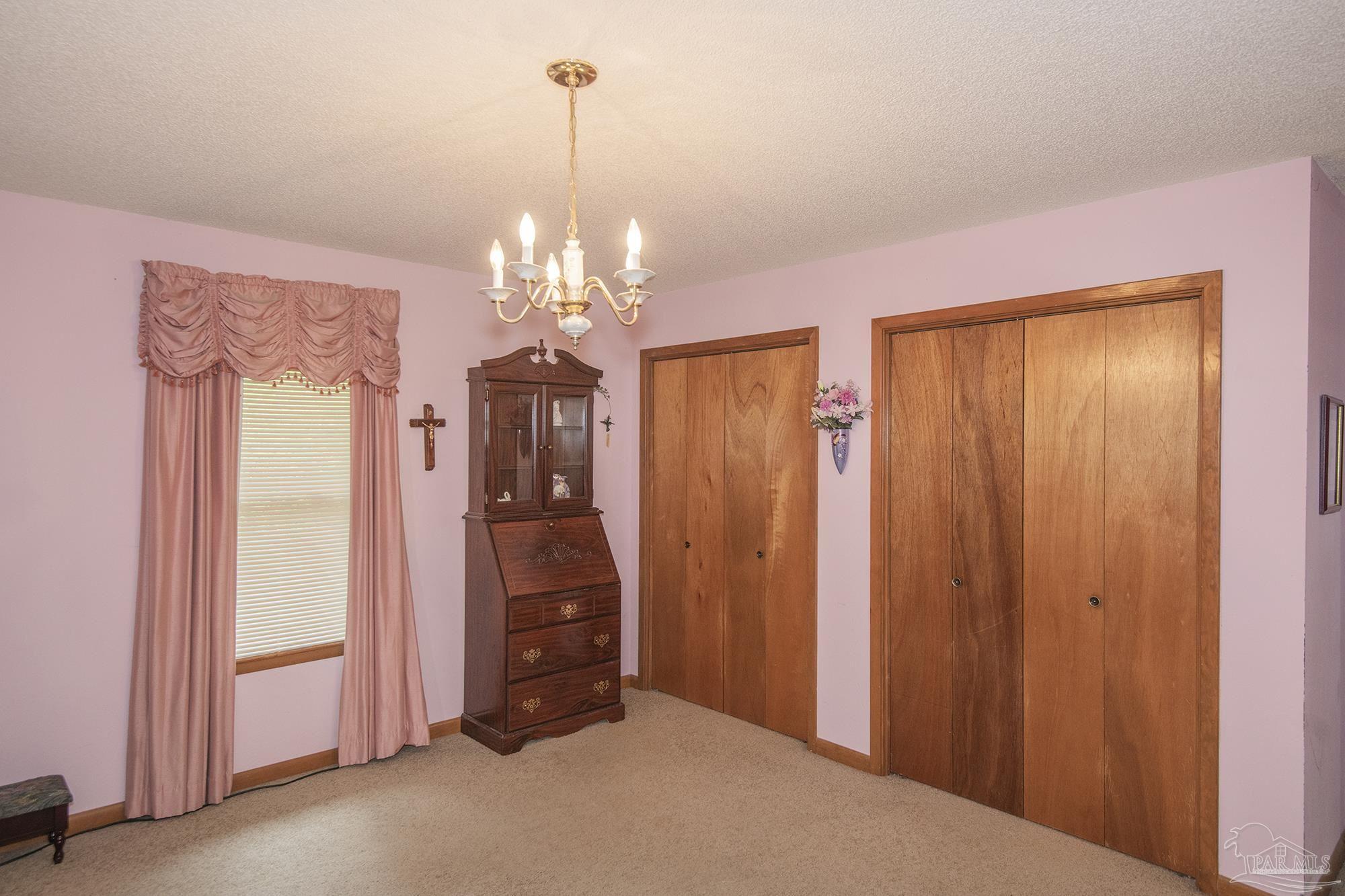 1210 Goldenrod Road Cantonment, FL 32533 - Photo 23 of 50 a view of a livingroom with a chandelier