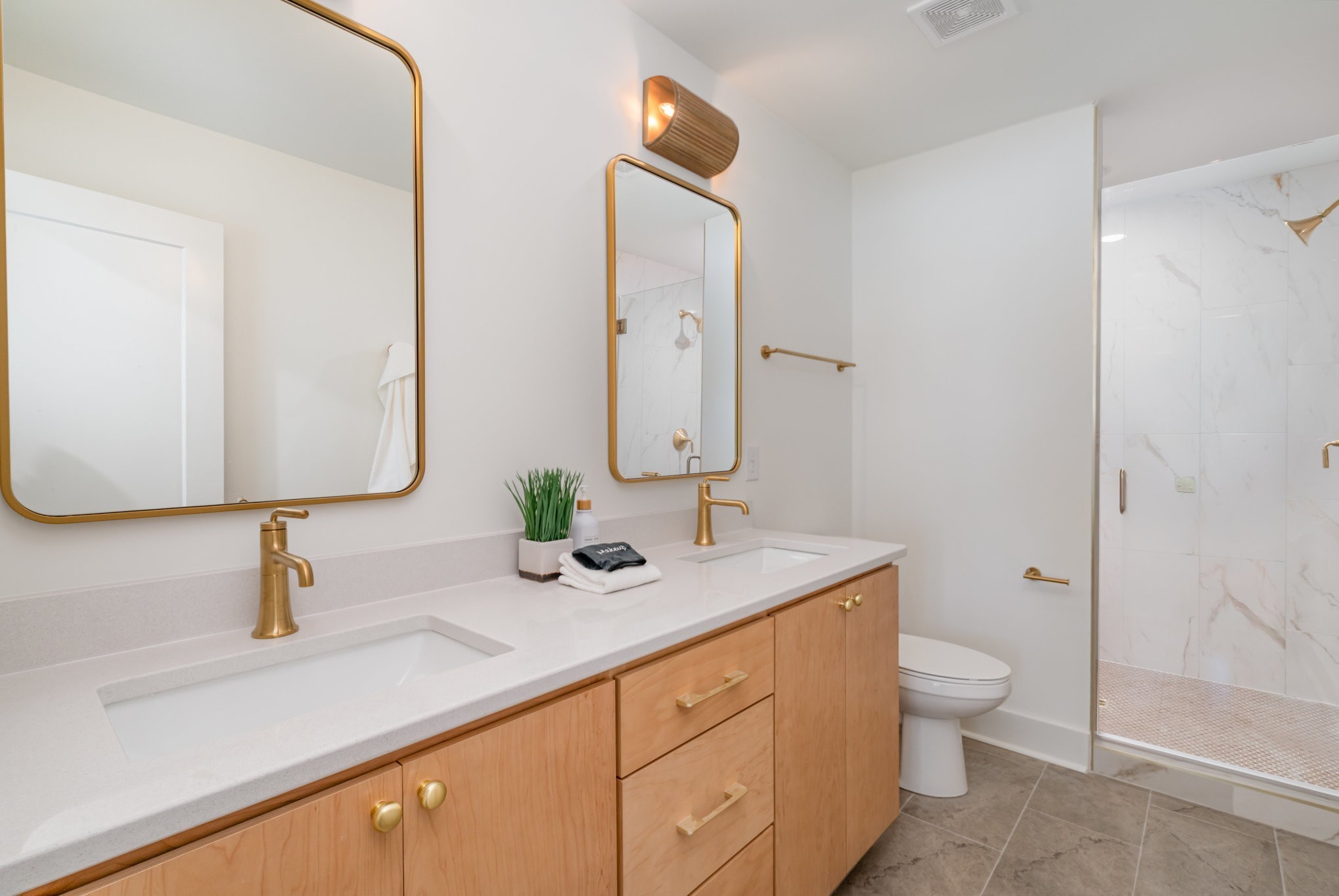 542 A Rosedale Avenue, Unit 10 Nashville, TN 37211 - Photo 13 of 33 a bathroom with a double vanity sink toilet and shower