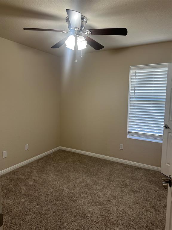 208 Pearl Drive Hewitt, TX 76643 - Photo 13 of 17 Carpeted spare room with baseboards and a ceiling fan