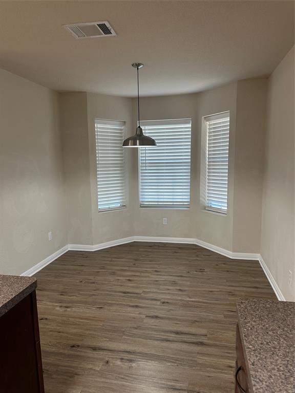 208 Pearl Drive Hewitt, TX 76643 - Photo 8 of 17 Unfurnished dining area with dark wood-style flooring and baseboards